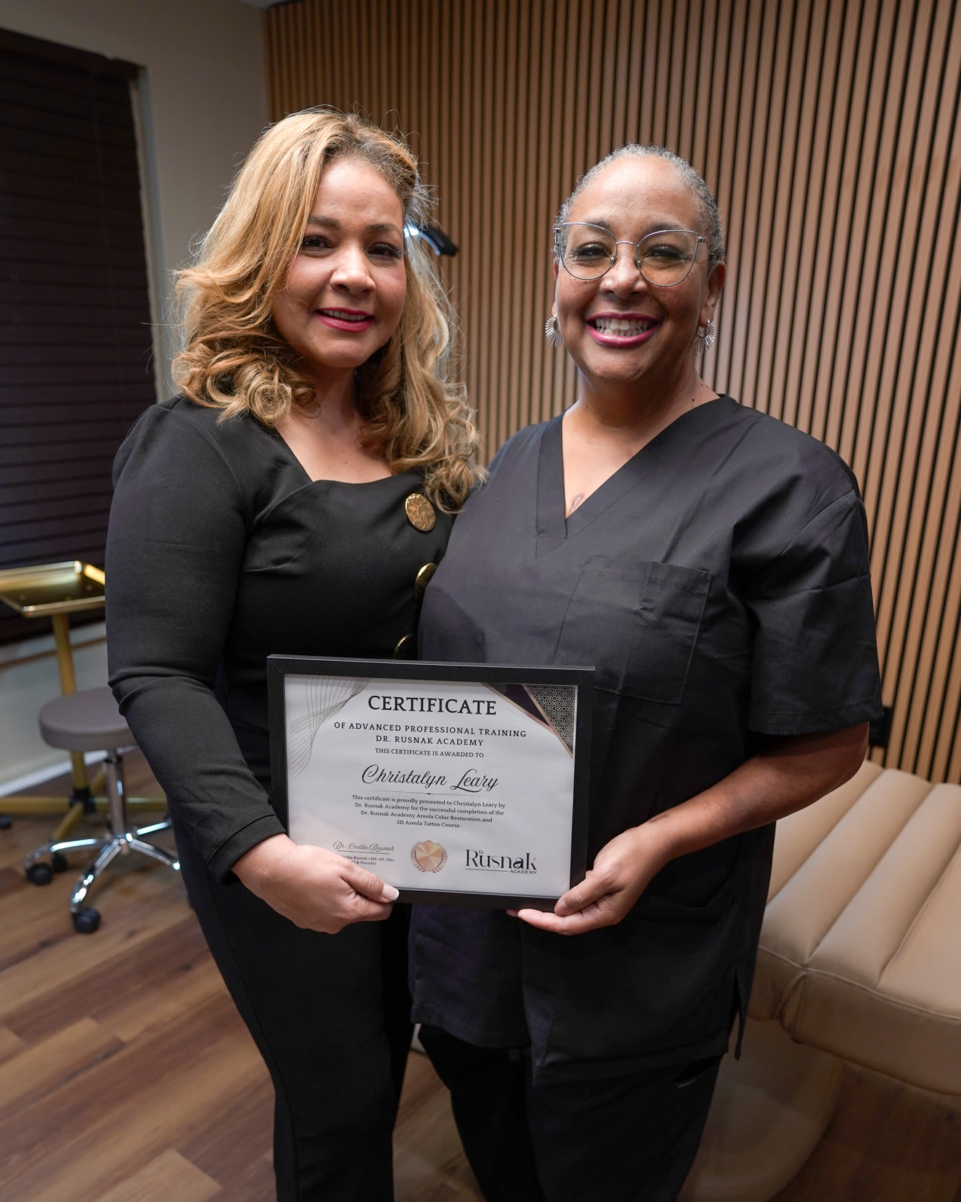 Dr. Rusnak presenting a masterclass graduate with her certificate