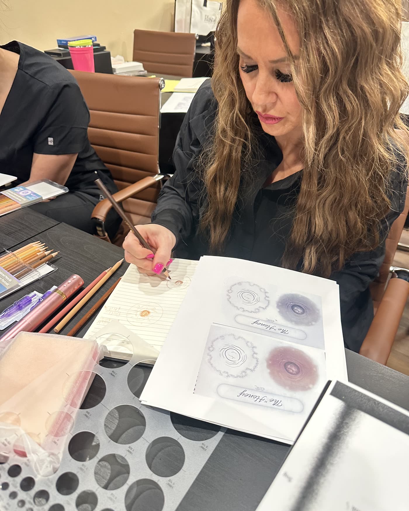 A candidate working through areola stencils and sketches