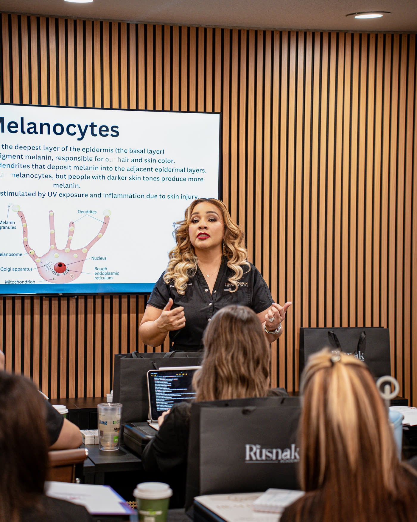 Dr. Cecilia Rusnak teaching skin anatomy to a cohort in the Academy classroom